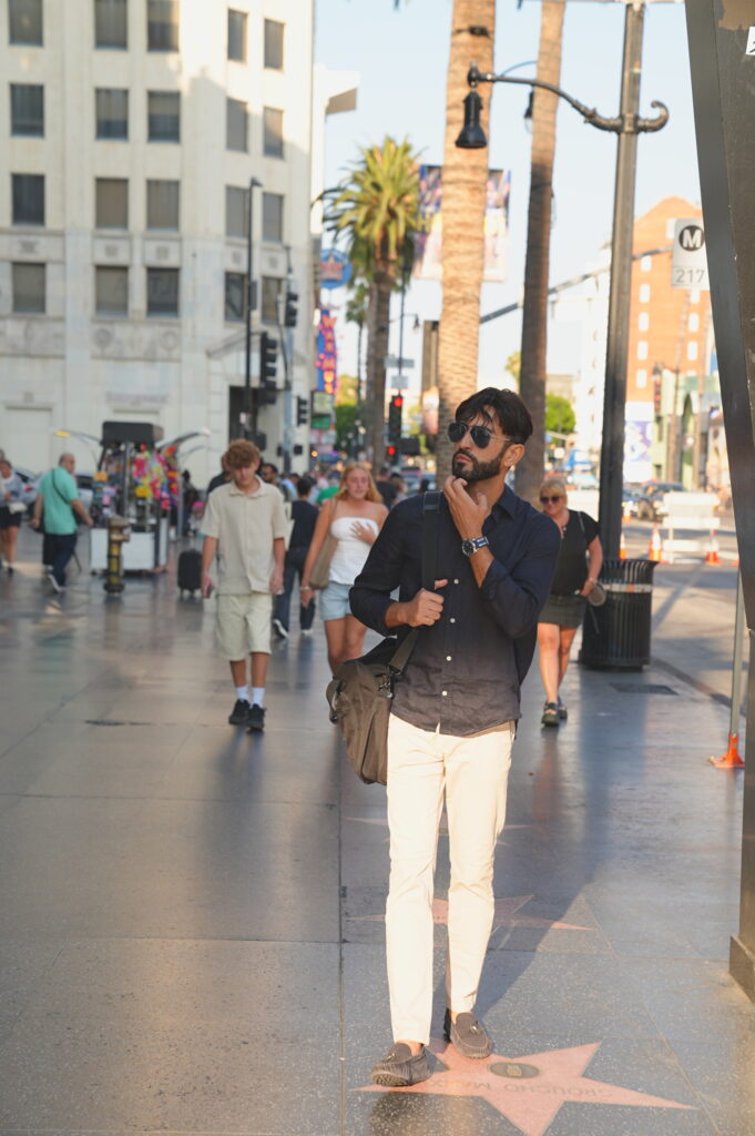 Young solo professional traveler posing confidently on the Hollywood Walk of Fame in Los Angeles, California, captured by Hollywood BL Photo.