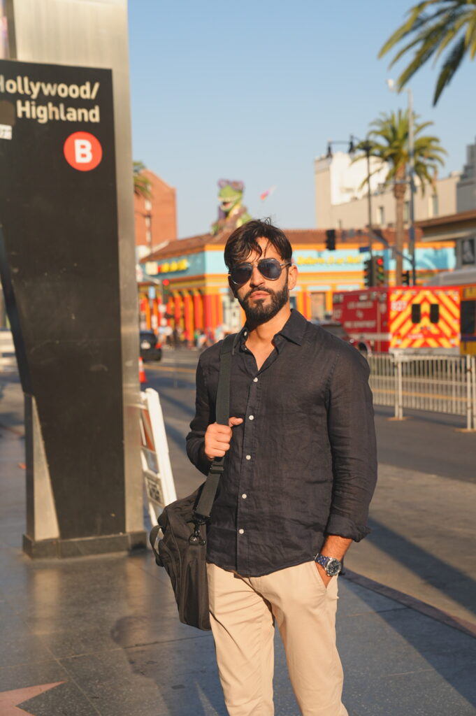 Young solo professional traveler posing confidently on the Hollywood Walk of Fame in Los Angeles, California, captured by Hollywood BL Photo.