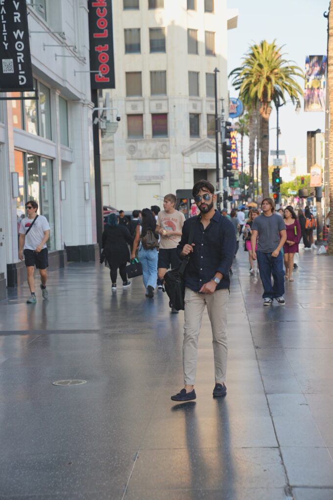 Young solo professional traveler posing confidently on the Hollywood Walk of Fame in Los Angeles, California, captured by Hollywood BL Photo.